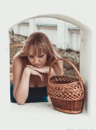 Girl with the basket in a little window