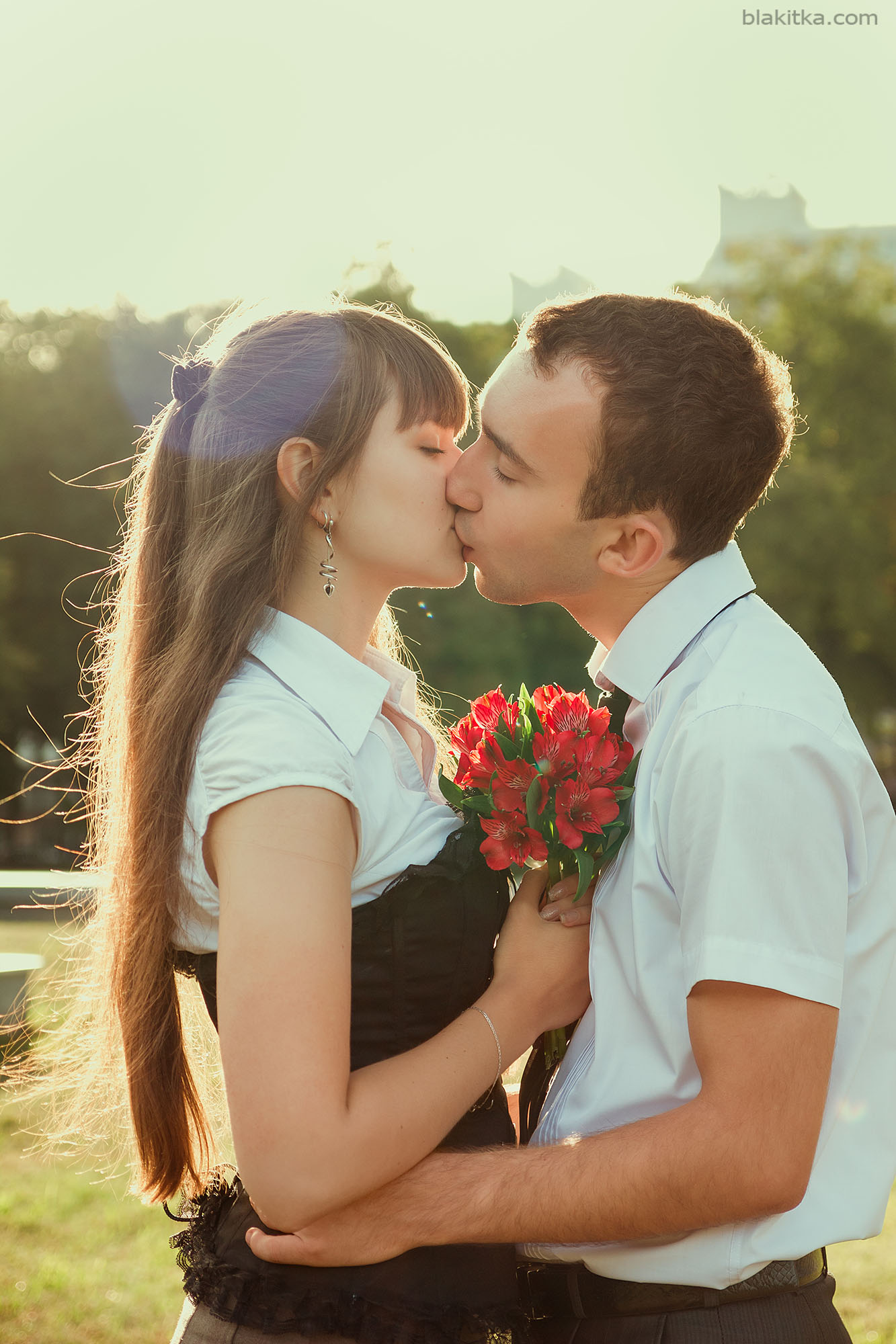 Young couple kissing in a sunshine